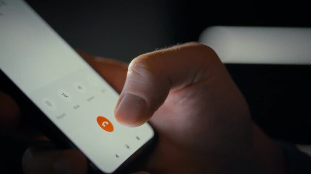On a smartphone screen, a man taps the touch keyboard to dial a number, Close-up shots capture the device's sleek display and his precise hand movements, showcasing digital interaction