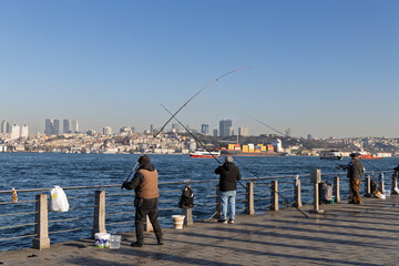 Fishermen angling with fishing rods on promenade by sea in Istanbul © RdB