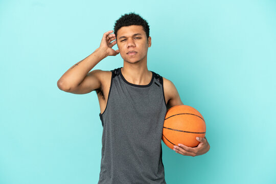 Basketball player African American man isolated on blue background having doubts