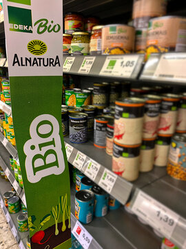 HOMBERG, GERMANY - AUGUST 30, 2026: An Edeka Bio and Alnatura sign in a supermarket aisle with canned organic food on the shelves in the background.