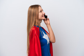 Super Hero Russian woman isolated on white background keeping a conversation with the mobile phone © luismolinero