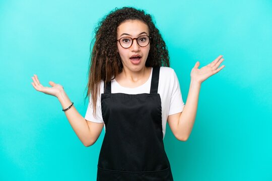 Restaurant waiter Arab woman isolated on blue background with shocked facial expression