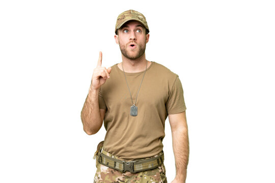 Military with dog tag over isolated chroma key background thinking an idea pointing the finger up