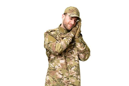 Military man over isolated chroma key background making sleep gesture in dorable expression