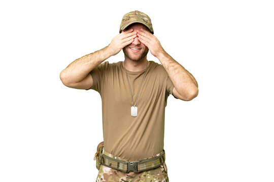 Military with dog tag over isolated chroma key background covering eyes by hands