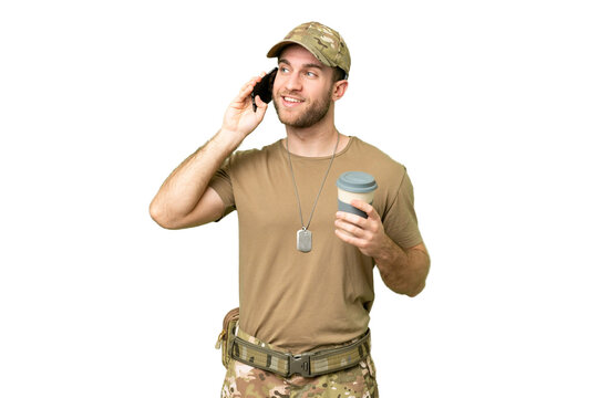 Military with dog tag over isolated chroma key background holding coffee to take away and a mobile