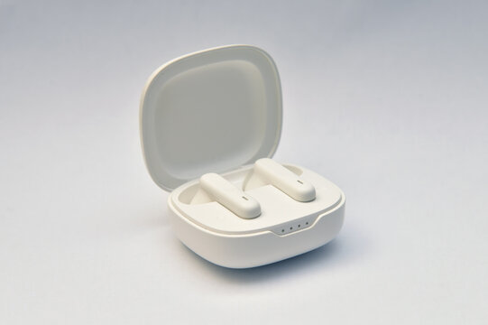 White wireless earphones in charging case