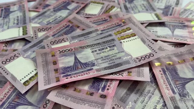 Slow Motion of Falling Bangladeshi Taka Banknotes on Pile of BDT Currency. Bangladeshi Taka