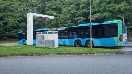 Modern electric bus charging at station for eco-friendly transportation © Sujan