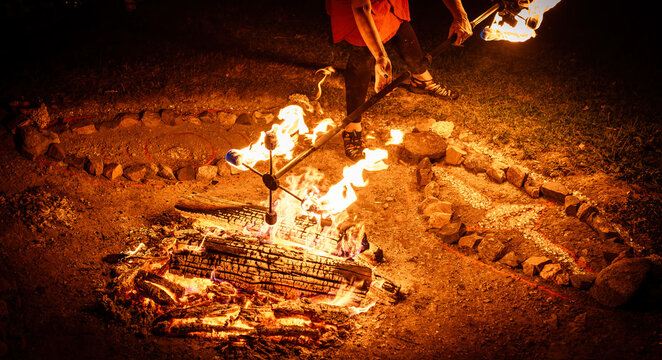 Close-up of Artist Lighting a Fire Stick at a Night Festival