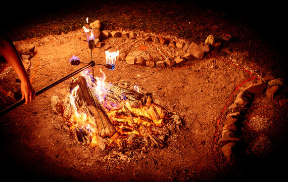 Close-up of Artist Lighting a Fire Stick at a Night Festival