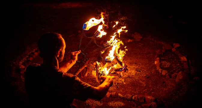 Close-up of Artist Lighting a Fire Stick at a Night Festival
