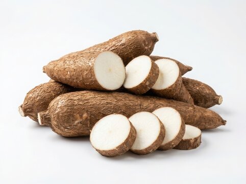 Fresh raw cassava roots and sliced pieces isolated on white background