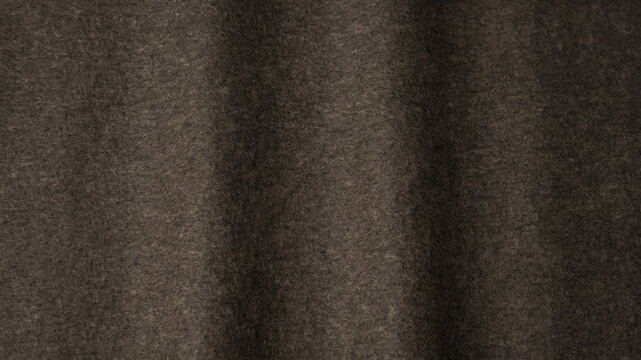 Dark grey fabric texture background. Soft wool textile material with elegant folds.