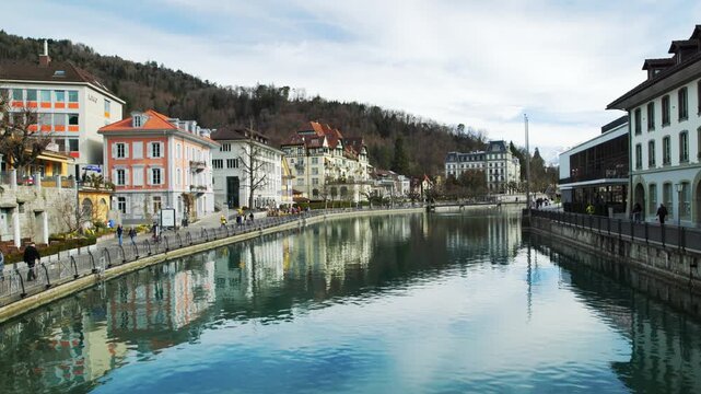Thun old town and church tower reflected in Aare river