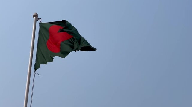 National Flag of Bangladesh Waving in Wind Against Clear Blue Sky. Bangladesh flag