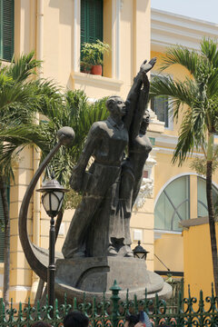 Socialist realism bronze monument of revolutionary workers with sickle on colonial building background, communist statue in Ho Chi Minh City, Vietnam - January 8, 2026