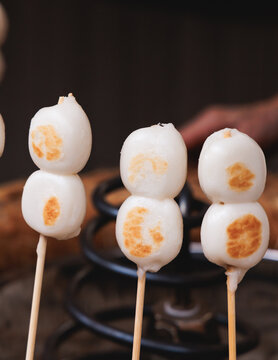 Dango on skewer, Mitarashi dango, traditional Japanese street food, grilled rice cake balls dumplings on wooden sticks, street food festival, Tokyo, Japan, market with local vendor stalls cooking