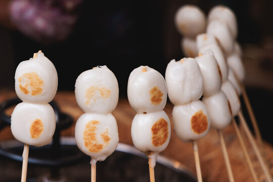 Dango on skewer, Mitarashi dango, traditional Japanese street food, grilled rice cake balls dumplings on wooden sticks, street food festival, Tokyo, Japan, market with local vendor stalls cooking
