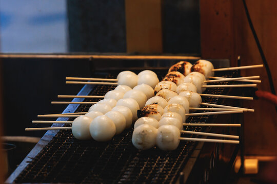 Dango on skewer, Mitarashi dango, traditional Japanese street food, grilled rice cake balls dumplings on wooden sticks, street food festival, Tokyo, Japan, market with local vendor stalls cooking
