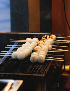 Dango on skewer, Mitarashi dango, traditional Japanese street food, grilled rice cake balls dumplings on wooden sticks, street food festival, Tokyo, Japan, market with local vendor stalls cooking