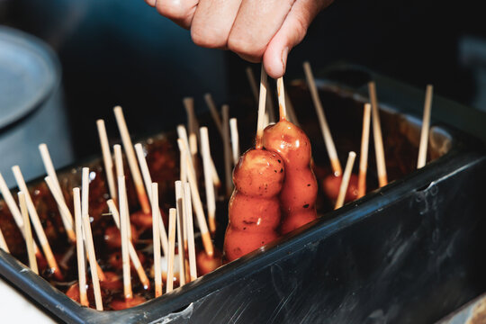 Dango on skewer, Mitarashi dango, traditional Japanese street food, grilled rice cake balls dumplings on wooden sticks, street food festival, Tokyo, Japan, market with local vendor stalls cooking