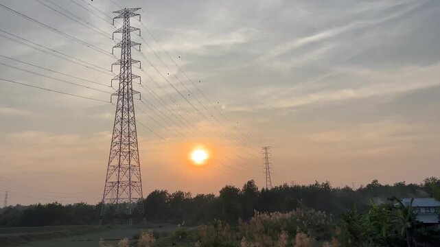 High Voltage Electricity Transmission Towers and Power Lines at Sunset in Bangladesh