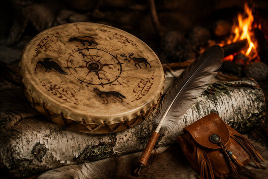 Shamanic frame drum with painted hide on birch log, spiritual and ritual tradition concept