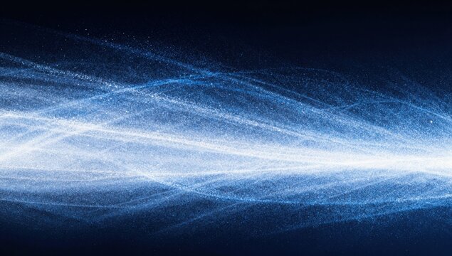 Soft blue glitter dust wave drifting on a dark background. Horizontal shimmering particle banner overlay for festive lighting effects, winter design and elegant wallpaper visuals