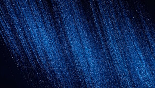 Diagonal blue glitter rain streaking across a dark background. Sparkling particle texture overlay for festive lighting effects, night visuals and modern banner design