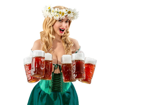 Woman waitress serving big beer mugs on isolated background during beer party. Blonde girl with wreath daisies flowers in her hair celebrating traditional beer festival.
