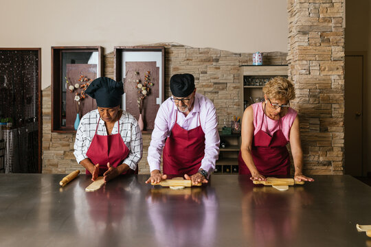 Chefs kneading dough during cooking course