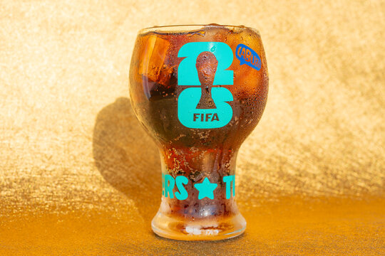 ZHONGSHAN China-June 23 2026: FIFA themed glass tumbler filled with iced cola soda drink.
