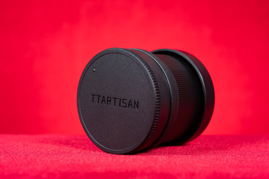 ZHONGSHAN China-May 30 2026: Matte black TTArtisan AF 50mm F1.8 prime auto focus camera lens with ribbed texture and USB charging port.