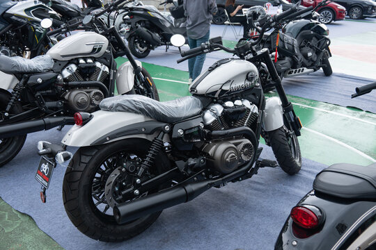 ZhongShan GuangDong China-April 11 2026: QJMOTOR BD250-15B light‑white retro cruiser motorcycle exhibited at outdoor motor show.