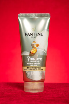 ZhongShan GuangDong China-March 13 2026: Pantene Pro‑V 3 Minute Miracle nourish smooth hair conditioner tube against red background.