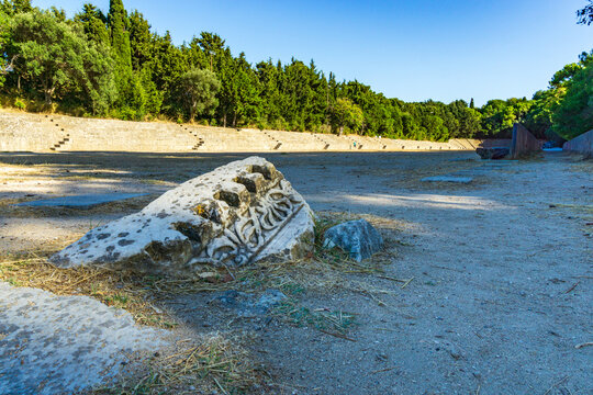 Ancient stadium of the Acropolis of Rhodes with carved stone relic surrounded by pine trees in Rhodes, in Greece