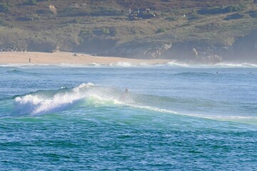 A powerful ocean wave with crystal-clear spray, ready for water sports © GenadiyGM