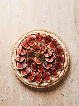Fresh fig tart with cream cheese filling and honey drizzle, top view