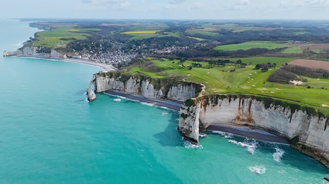 Eroded chalk coastline of Normandy with classic cliff formations on French coast. Aerial footage for geology and environment topics