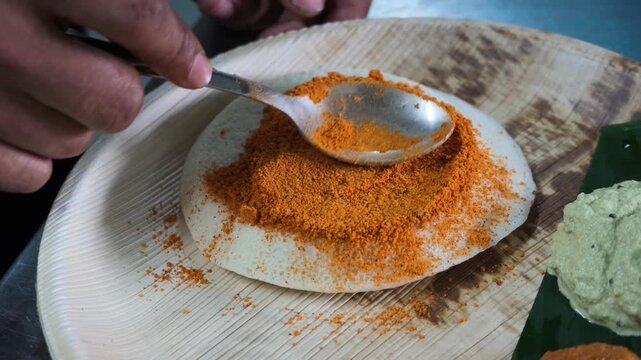 South indian idli served with spicy podi and coconut chutney