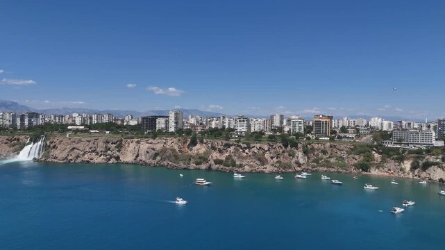 Amazing Antalya city view with Duden waterfall, yachts and boats by the coast and apartments in the background, T&uuml;rkiye  