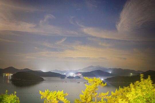 Starry Night Sky with Wispy Cirrus Clouds Over Coastal Islands and Bay in Jindo, South Korea