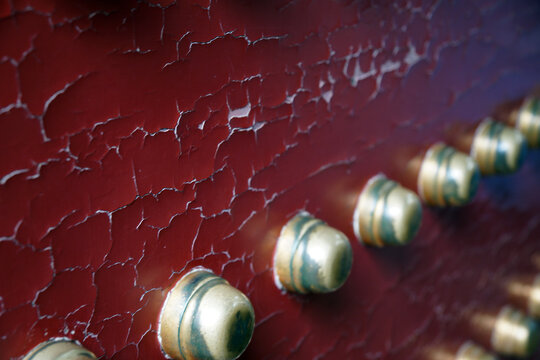 Cracked Red Paint with Brass Rivets Detail