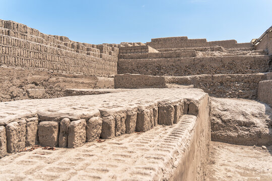 The complex, terraced adobe brick construction of the ancient Huaca Pucllana pyramid in the Miraflores district of Lima