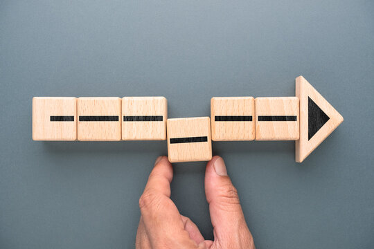 Hand correcting a misaligned element to restore a clear path forward, representing problem solving, process improvement, intervention, workflow optimization, and removing bottlenecks