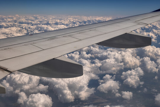 Aerial View With Airplane Wing Above Clouds