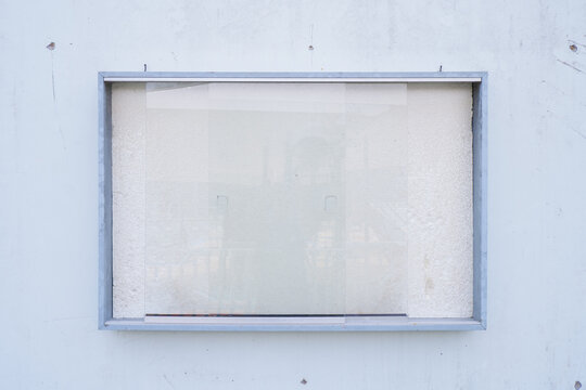 Blank Notice Board Mockup on Concrete Wall with Glass Frame for Poster Display and Announcement Template