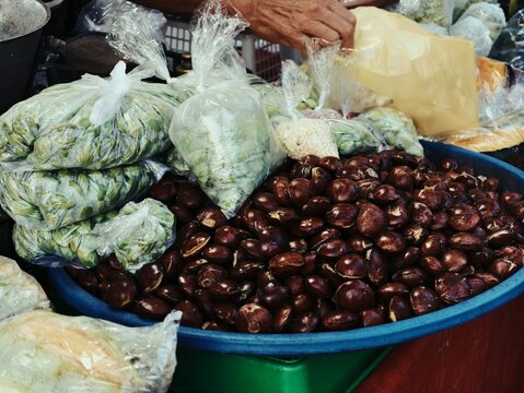Fresh jeringa beans and shelled stinky beans in plastic bags at Indonesian market