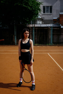 Young woman playing tennis on clay court